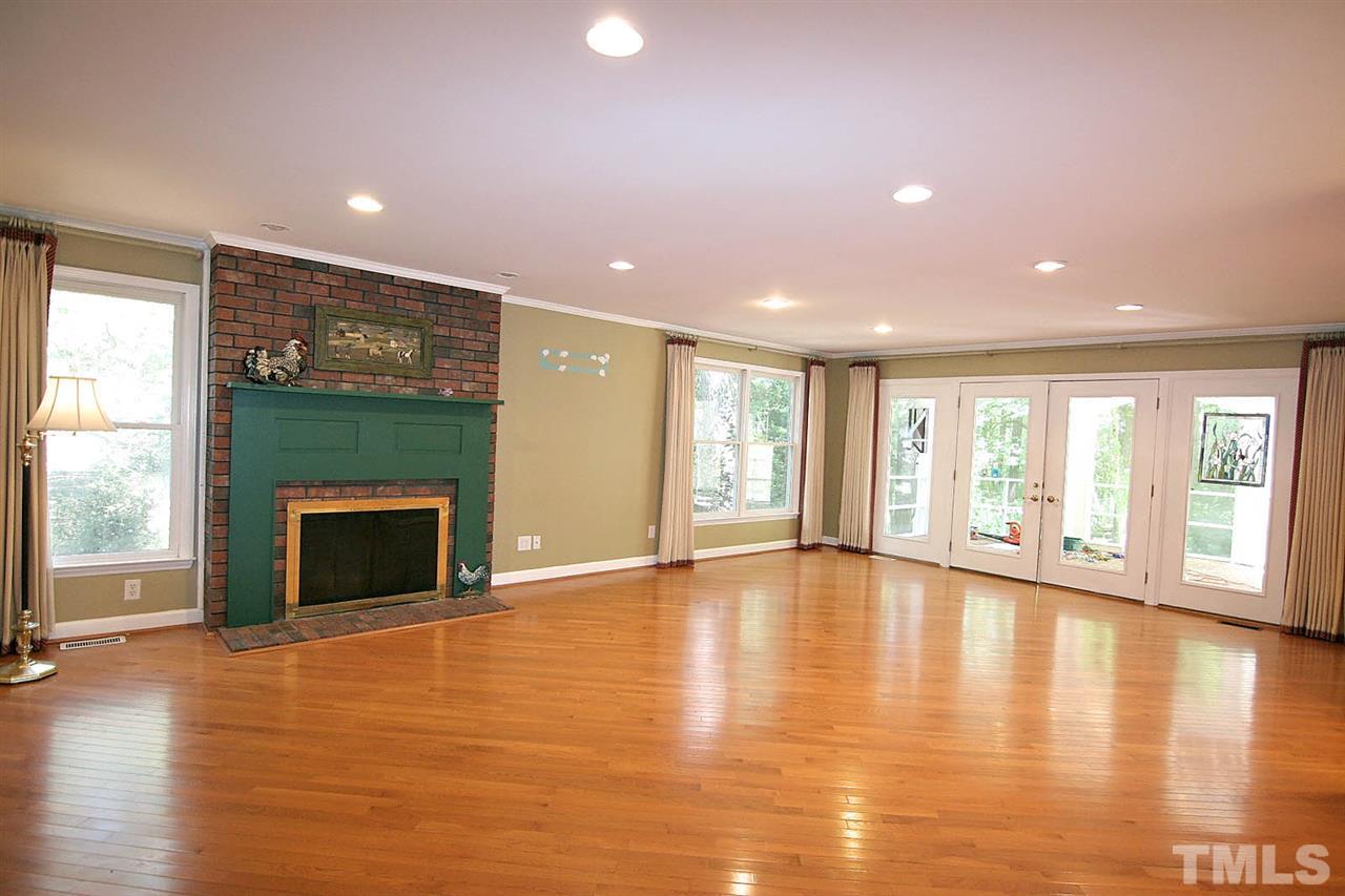 218 Queensferry Road Cary, NC 27511 - Photo 11 of 25 a view of an empty room with wooden floor and a window