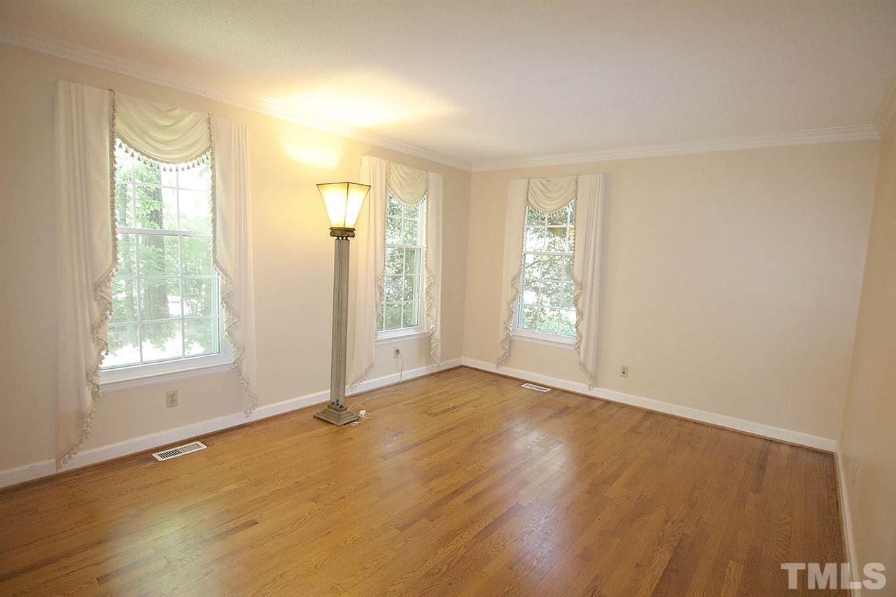218 Queensferry Road Cary, NC 27511 - Photo 13 of 25 an empty room with wooden floor and windows