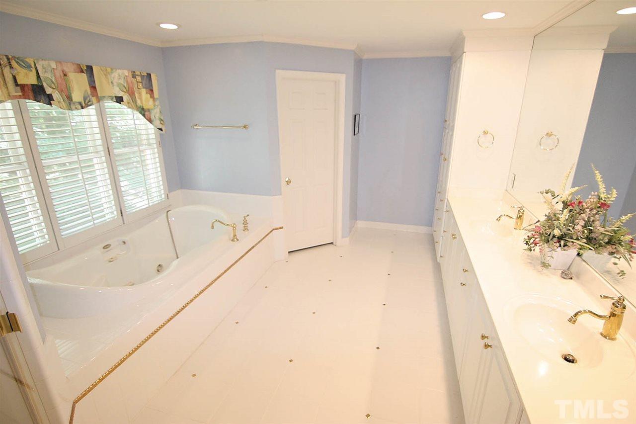 218 Queensferry Road Cary, NC 27511 - Photo 16 of 25 a bathroom with a bathtub and a shower