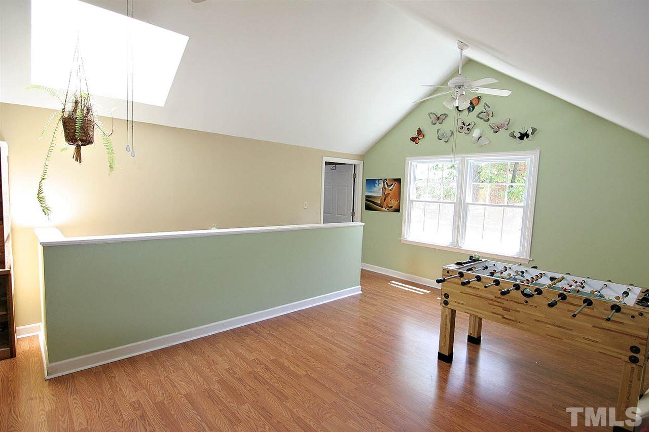 218 Queensferry Road Cary, NC 27511 - Photo 17 of 25 a view of an empty room with window and wooden floor