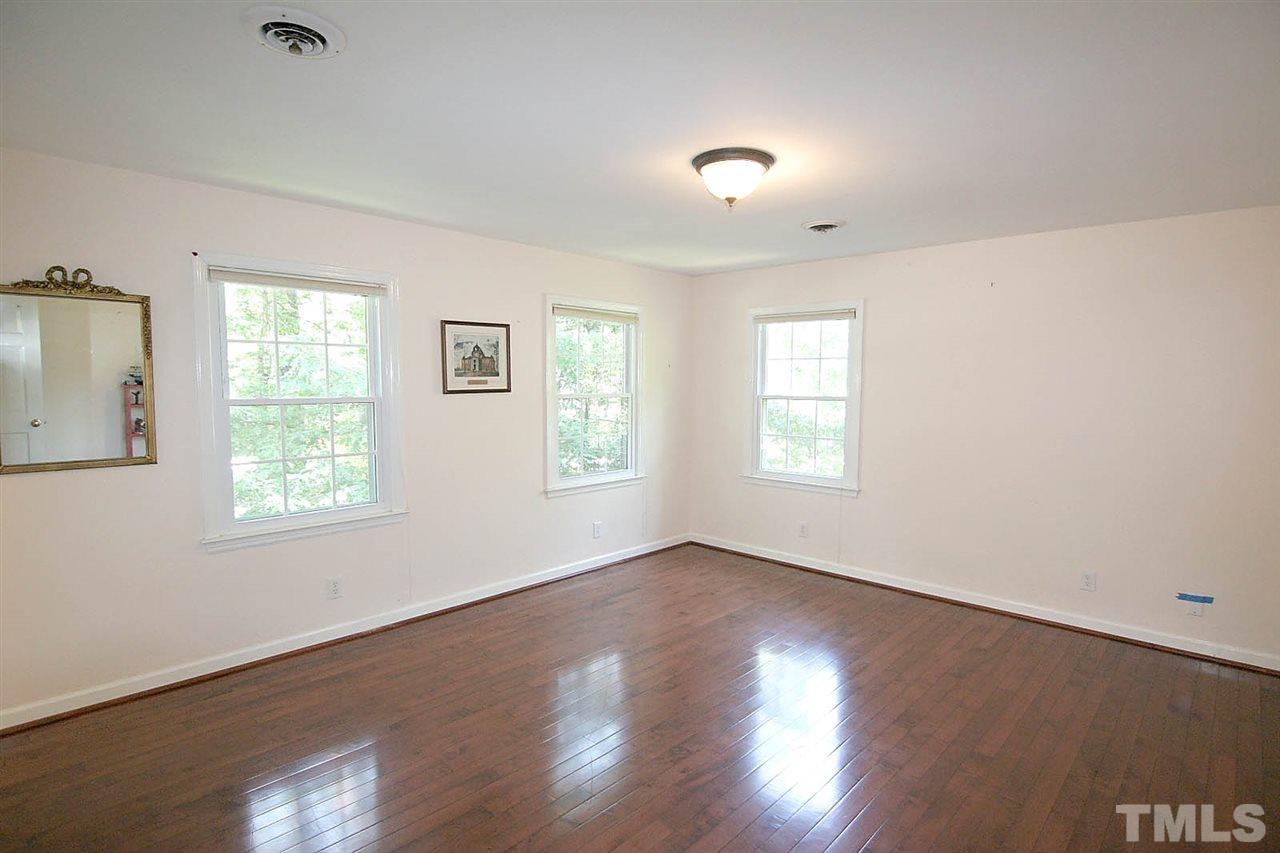 218 Queensferry Road Cary, NC 27511 - Photo 19 of 25 a view of an empty room with wooden floor and a window