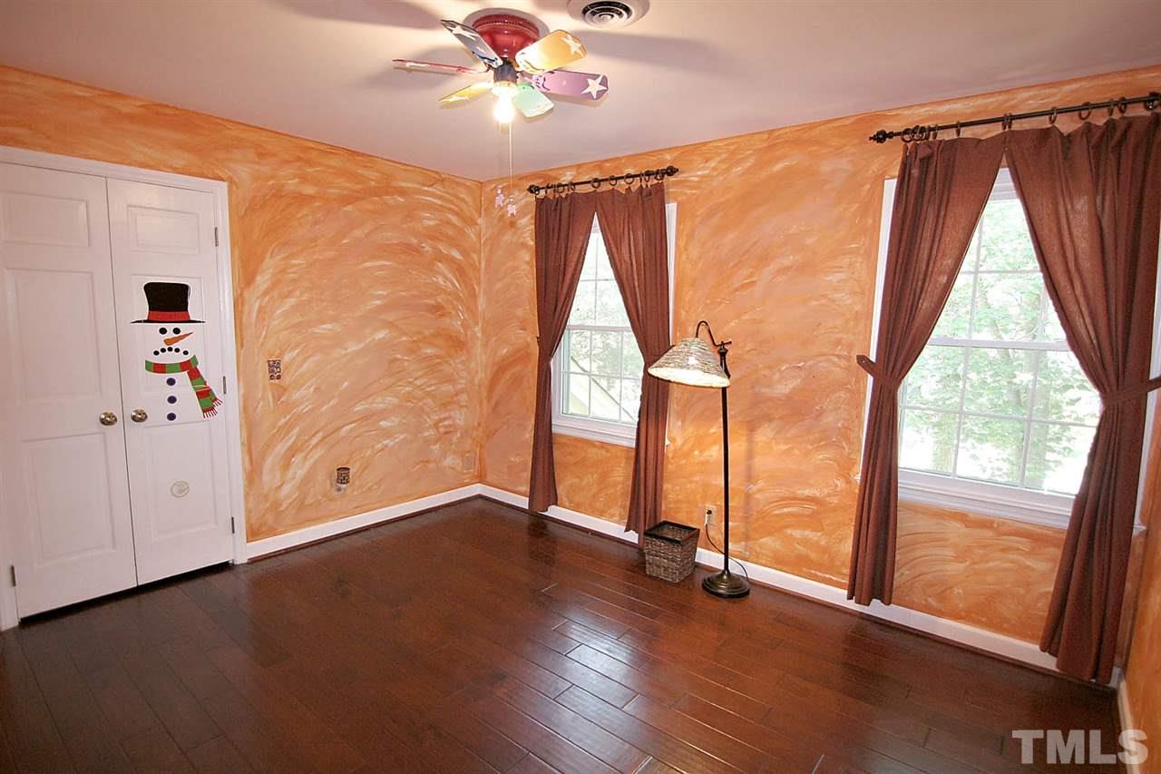 218 Queensferry Road Cary, NC 27511 - Photo 20 of 25 a view of an empty room with wooden floor and a window