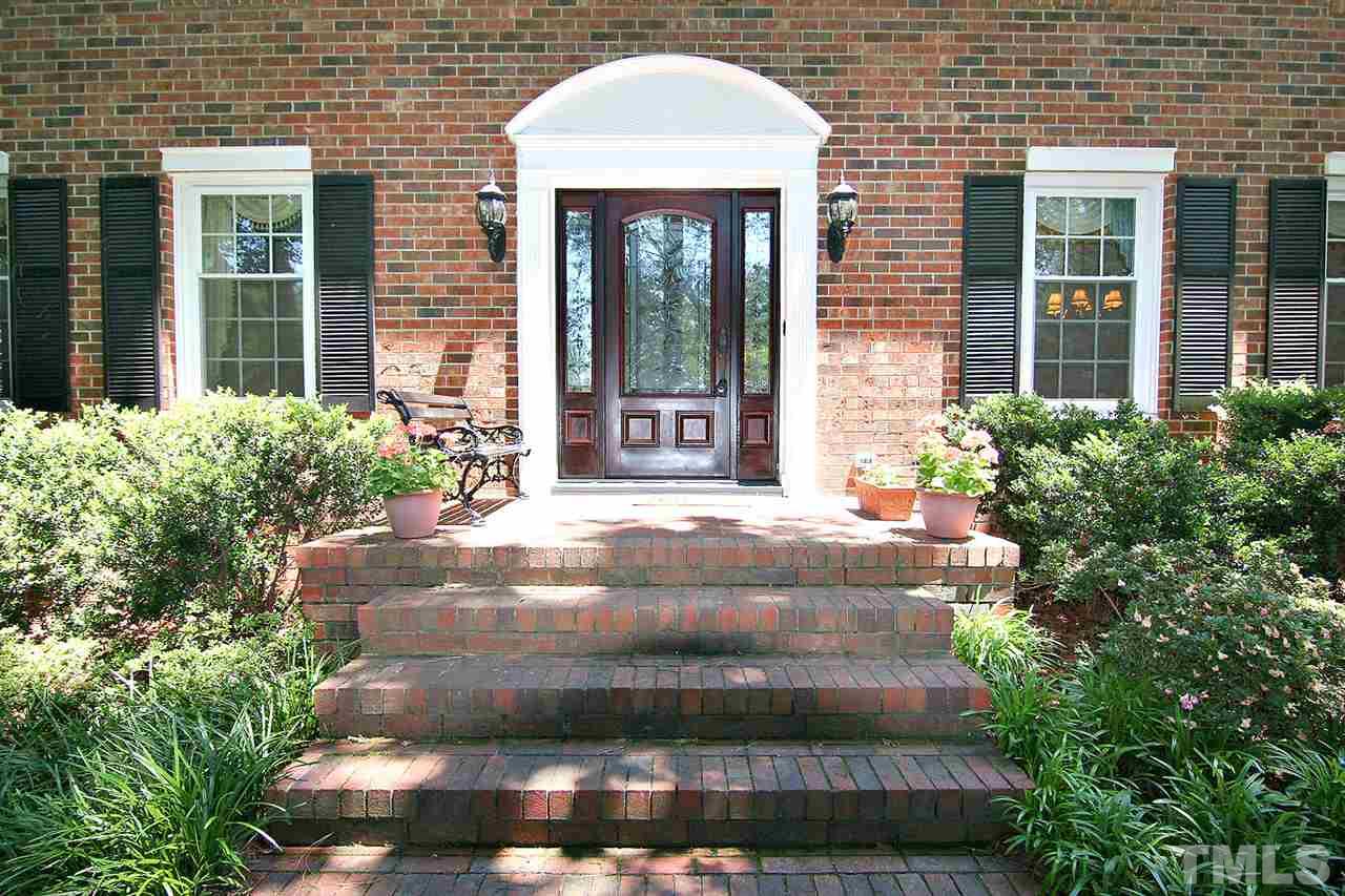 218 Queensferry Road Cary, NC 27511 - Photo 5 of 25 a view of a brick house with potted plants