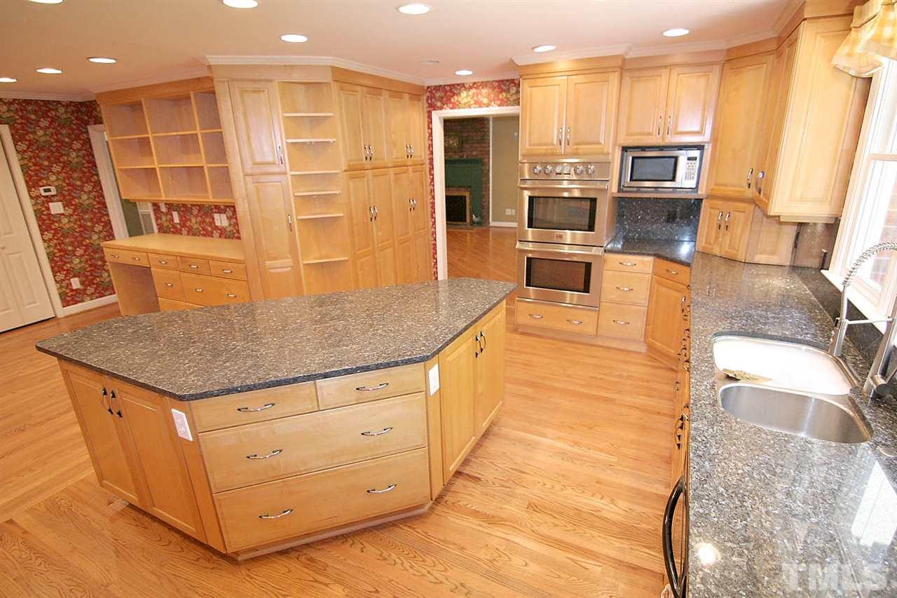 218 Queensferry Road Cary, NC 27511 - Photo 8 of 25 a kitchen with stainless steel appliances granite countertop a sink and a refrigerator