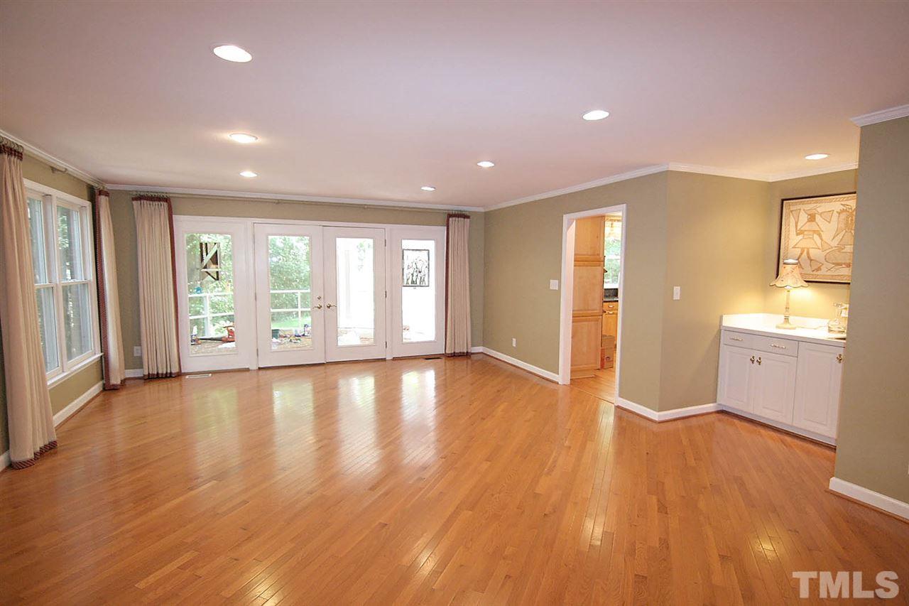 218 Queensferry Road Cary, NC 27511 - Photo 10 of 25 a view of an empty room with wooden floor and a window