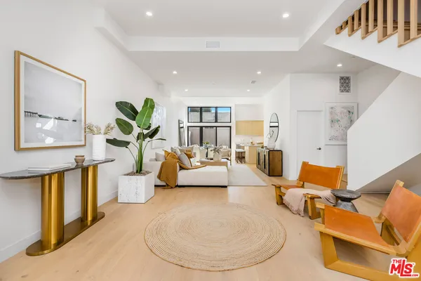 a living room with furniture and a potted plant