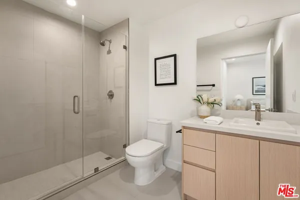 a bathroom with a toilet a sink and shower