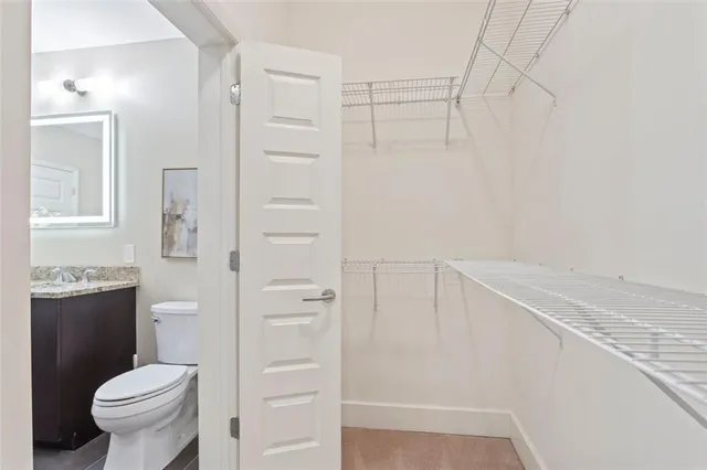 a bedroom with bed and a large window