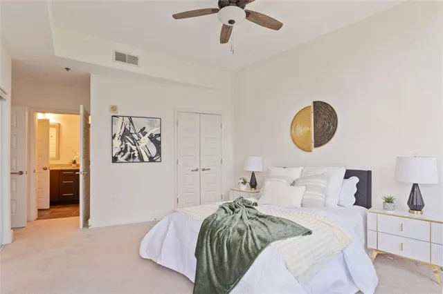 a bathroom with a granite countertop sink a toilet and a mirror