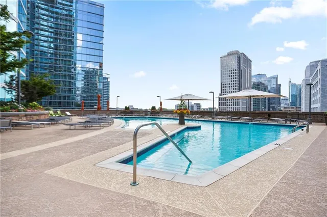 a dining room with furniture and a floor to ceiling window