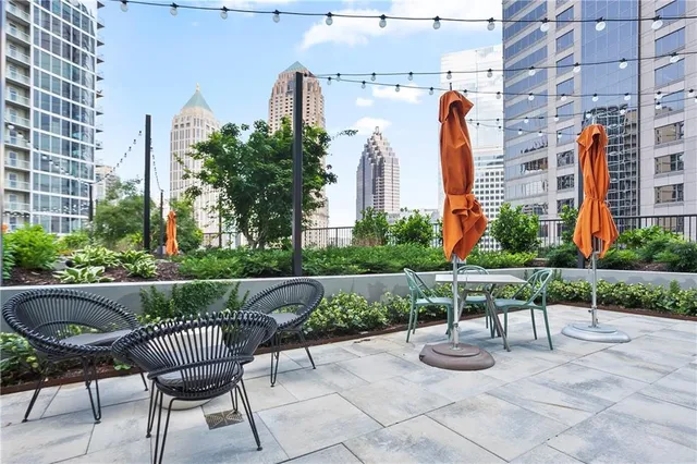 a view of a patio with couches and a potted plant on a floor