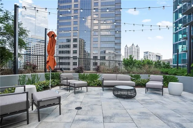 a view of building with a tub and trees in the background