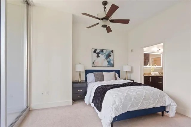 a bedroom with a large bed and a chandelier
