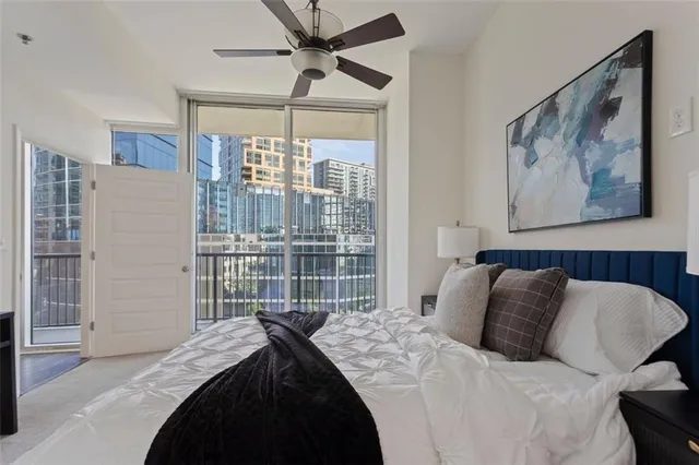 a bedroom with a bed and a painting on the wall