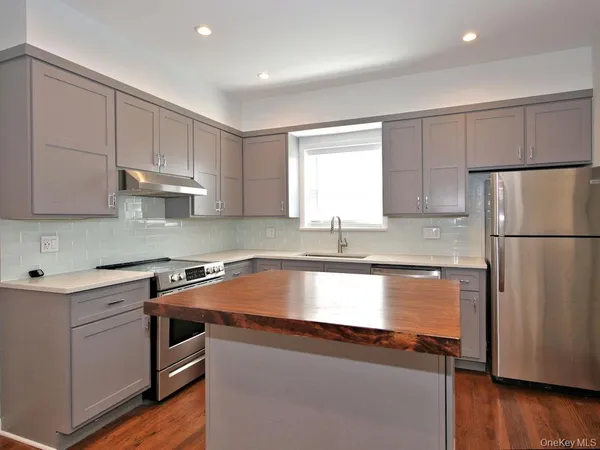 a kitchen with stainless steel appliances granite countertop a refrigerator sink and cabinets