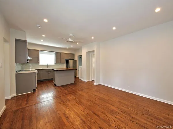 a large kitchen with stainless steel appliances granite countertop a large counter top and a stove top oven