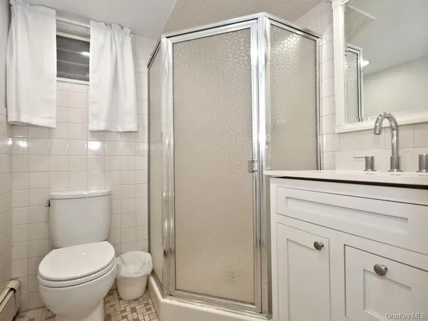 a bathroom with a shower and a toilet