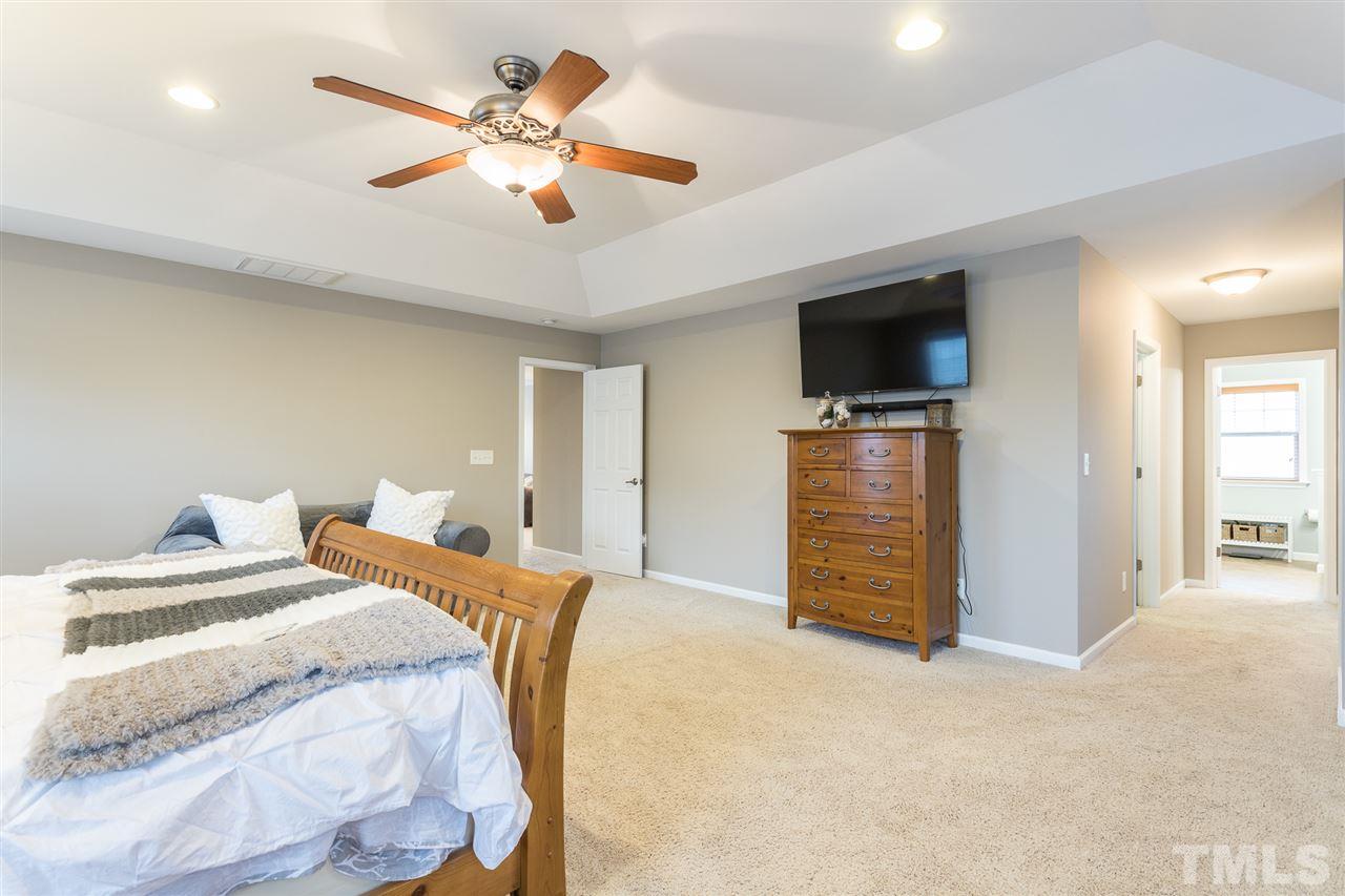 107 Locke Woods Road Raleigh, NC 27603 - Photo 17 of 30 a bedroom with a bed and a flat screen tv