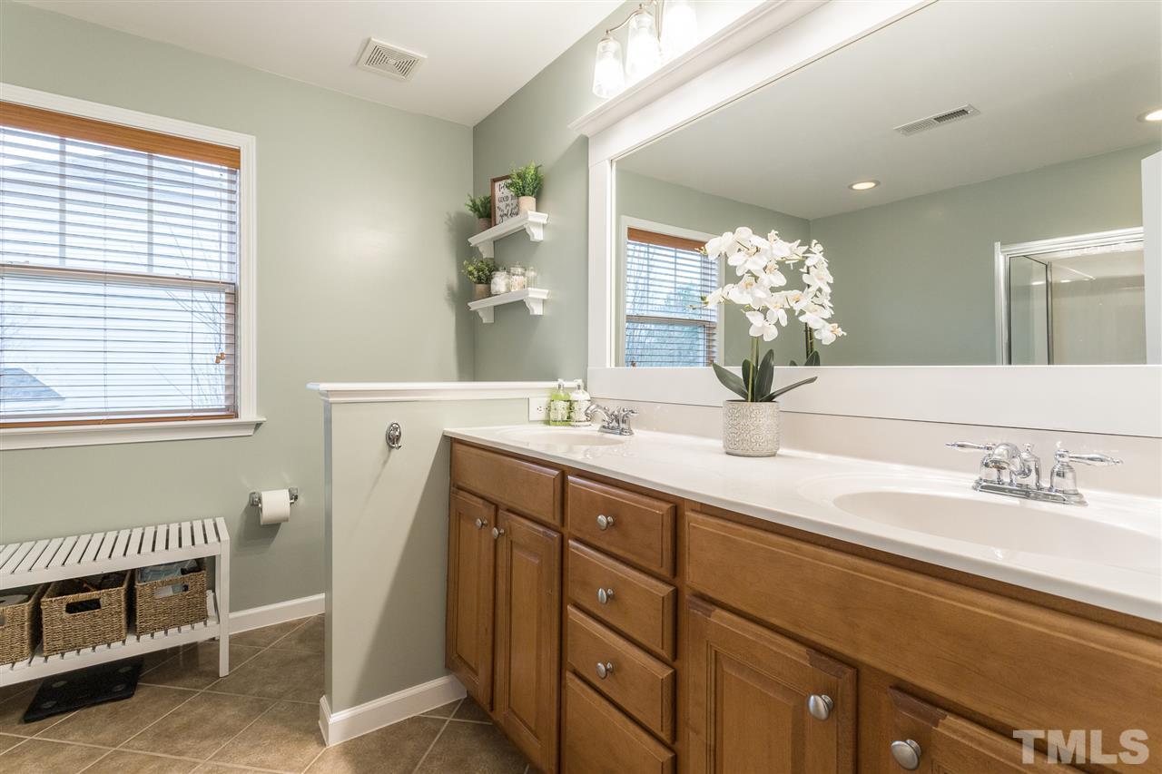 107 Locke Woods Road Raleigh, NC 27603 - Photo 18 of 30 a bathroom with a double vanity sink and a mirror