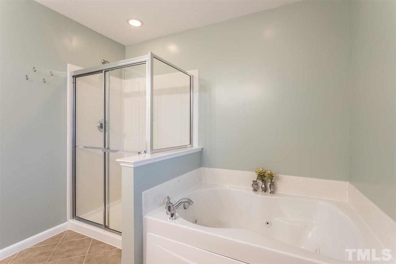 107 Locke Woods Road Raleigh, NC 27603 - Photo 19 of 30 a bathroom with a bathtub and a shower
