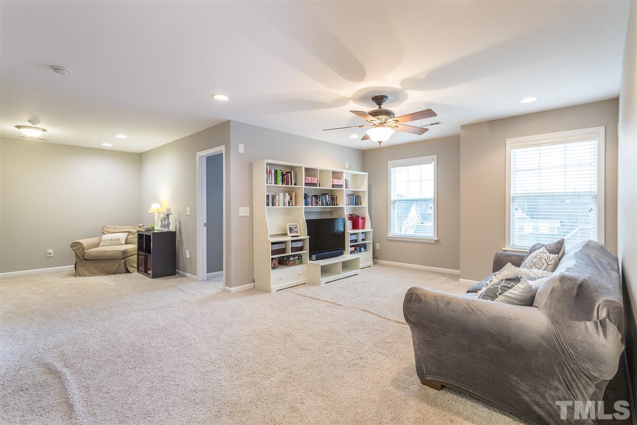 107 Locke Woods Road Raleigh, NC 27603 - Photo 20 of 30 a living room with furniture a ceiling fan and a large window