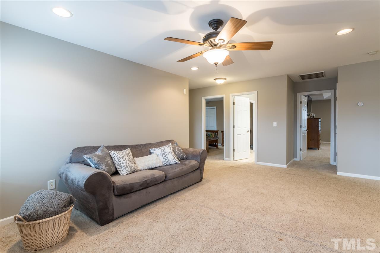 107 Locke Woods Road Raleigh, NC 27603 - Photo 21 of 30 a living room with furniture and a chandelier
