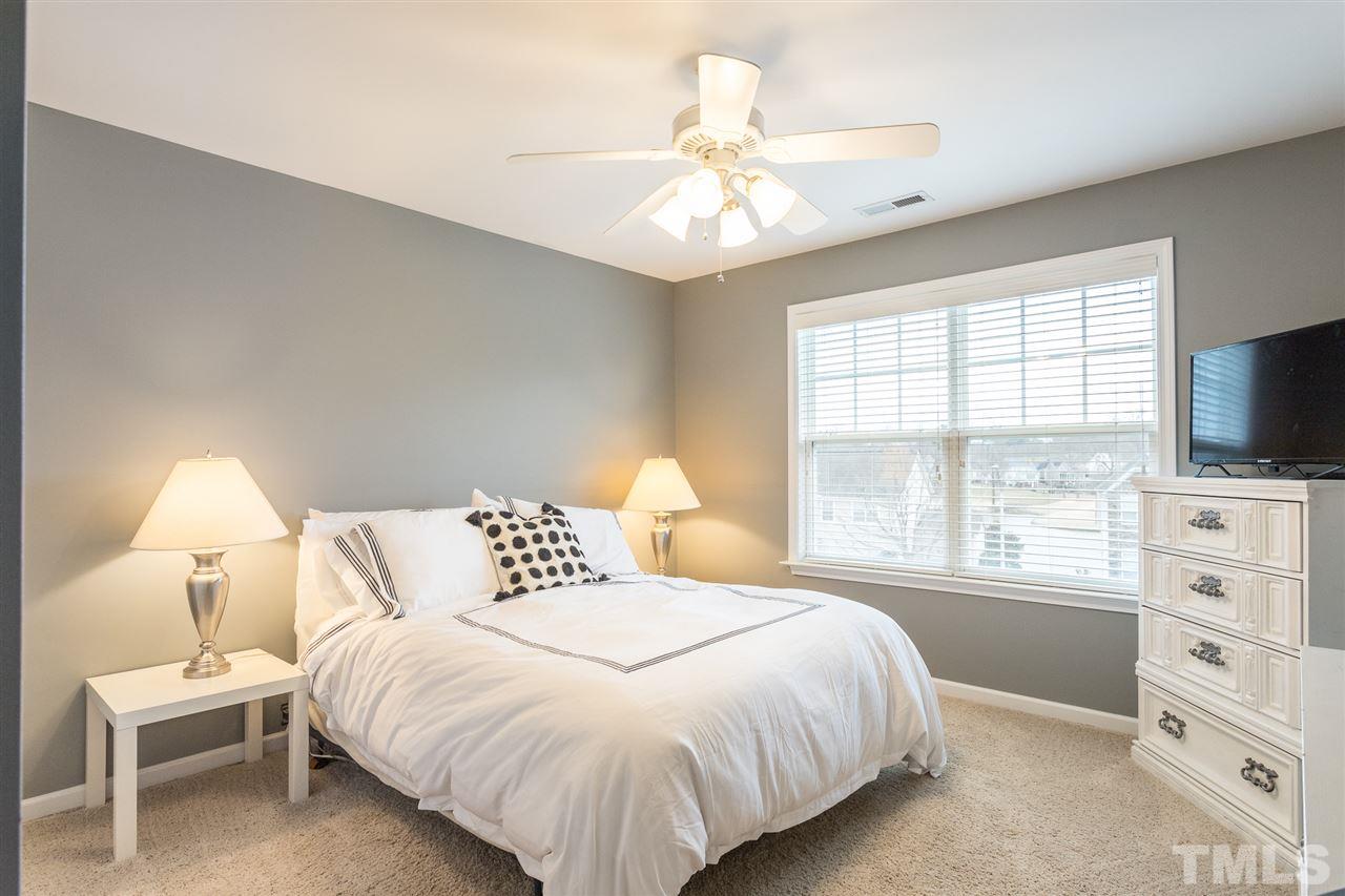 107 Locke Woods Road Raleigh, NC 27603 - Photo 25 of 30 a bedroom with a large bed and a flat tv screen on a dresser