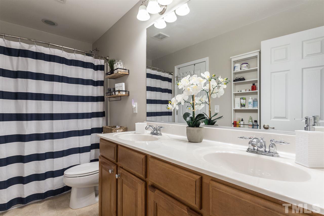 107 Locke Woods Road Raleigh, NC 27603 - Photo 26 of 30 a bathroom with a sink a toilet and a mirror
