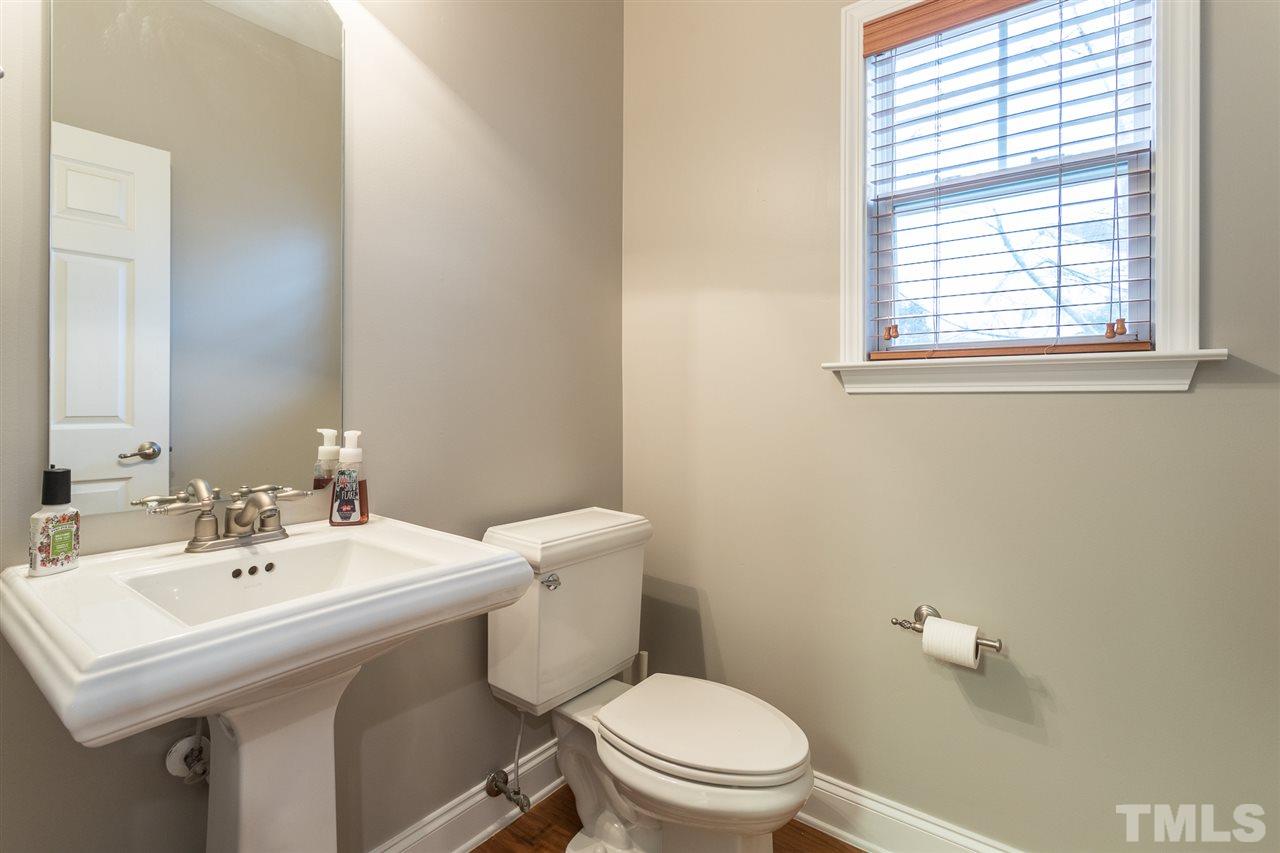 107 Locke Woods Road Raleigh, NC 27603 - Photo 28 of 30 a bathroom with a sink a toilet and a mirror