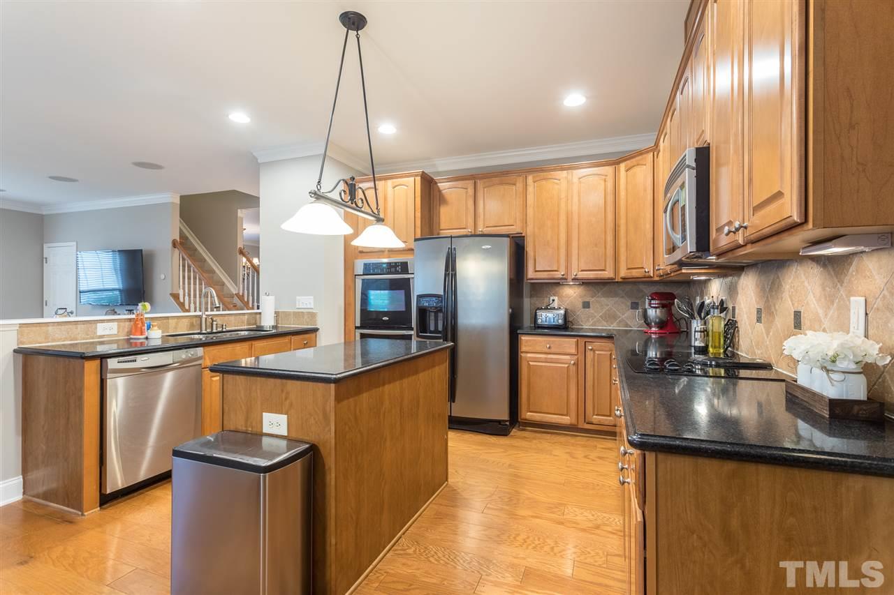 107 Locke Woods Road Raleigh, NC 27603 - Photo 8 of 30 a kitchen with stainless steel appliances granite countertop a sink a stove and refrigerator