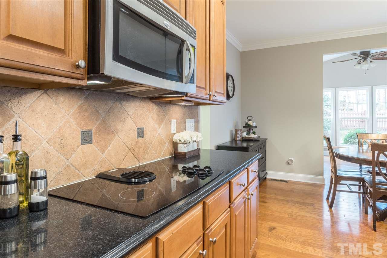 107 Locke Woods Road Raleigh, NC 27603 - Photo 9 of 30 a kitchen with stainless steel appliances granite countertop a sink a stove and a microwave