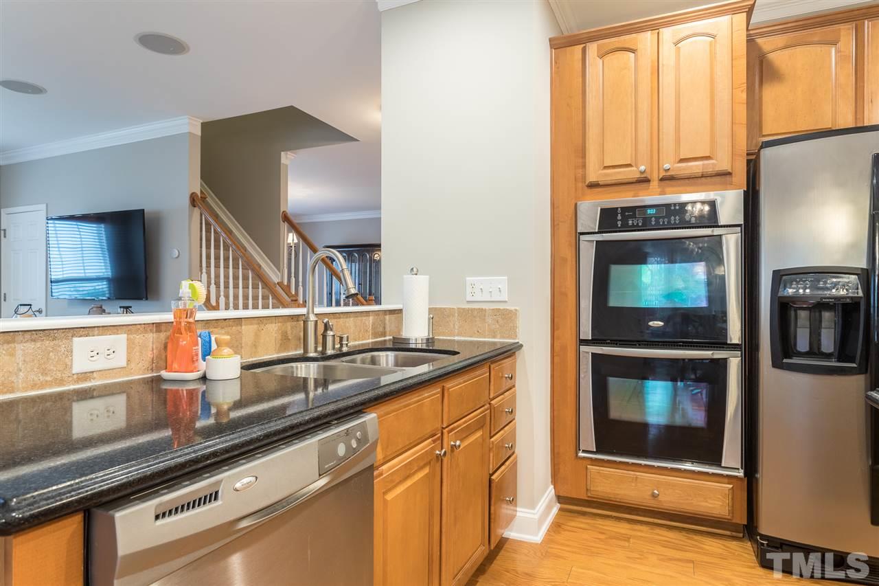 107 Locke Woods Road Raleigh, NC 27603 - Photo 10 of 30 a kitchen with a sink and a refrigerator