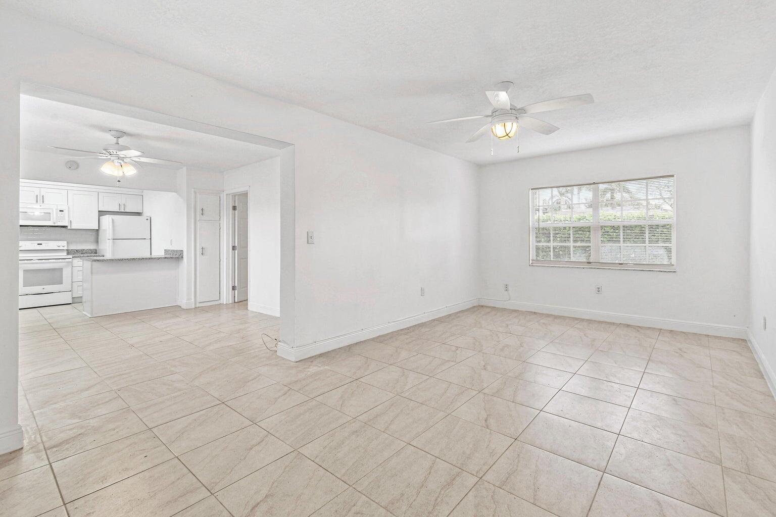 101 Akron Street, Unit 101 Lake Worth Beach, FL 33461 - Photo 3 of 11 a view of an empty room with a kitchen
