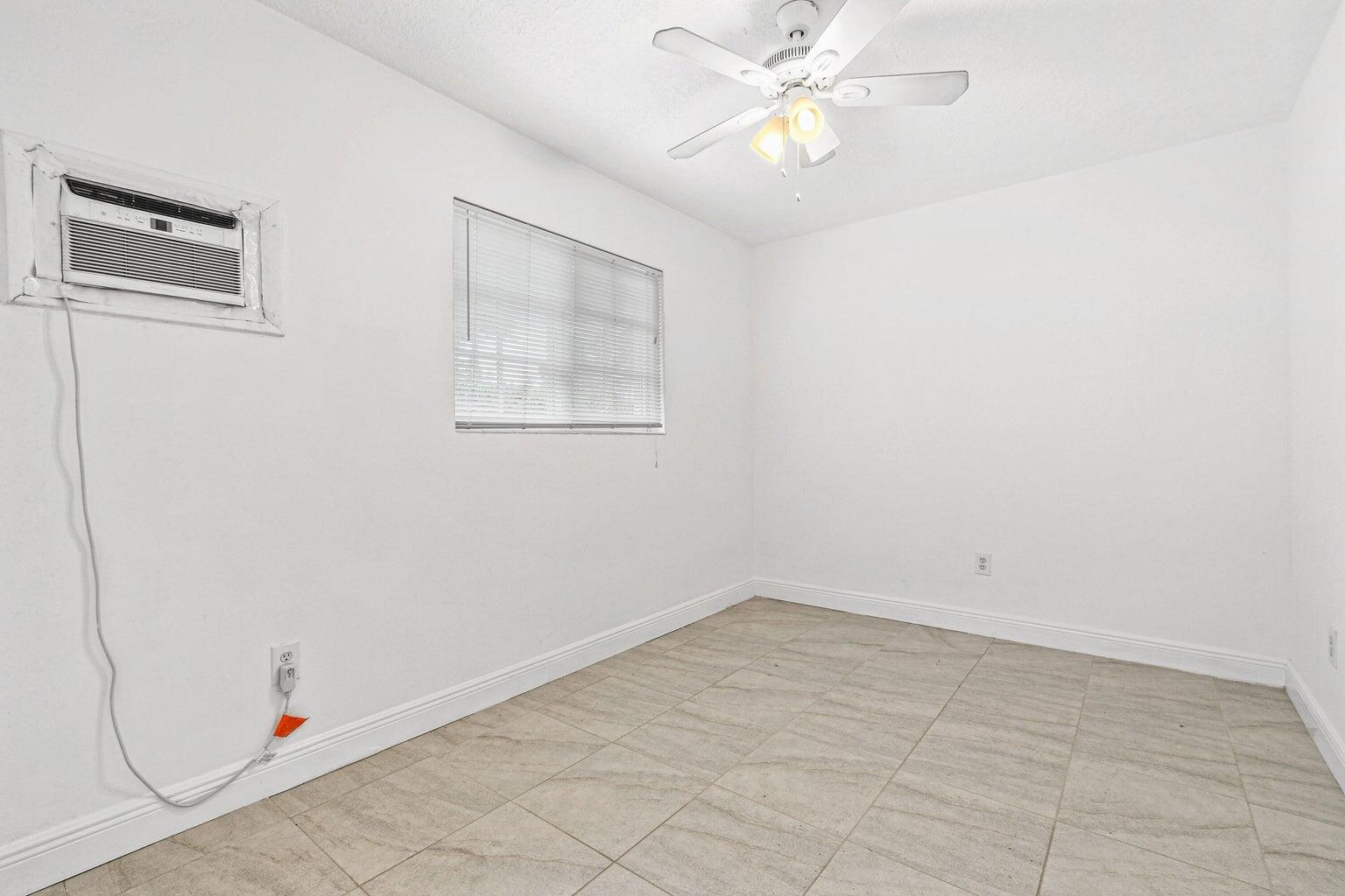 101 Akron Street, Unit 101 Lake Worth Beach, FL 33461 - Photo 7 of 11 wooden floor in an empty room