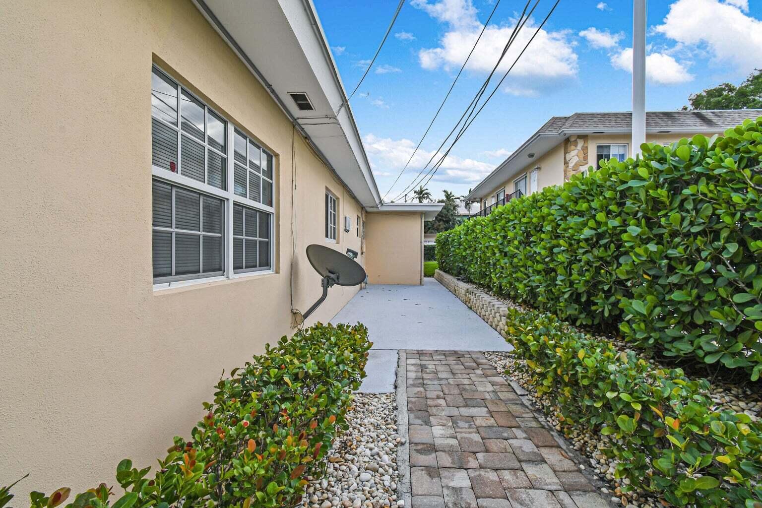 101 Akron Street, Unit 101 Lake Worth Beach, FL 33461 - Photo 10 of 11 a front view of a house with garden