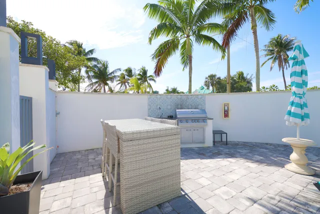 a view of swimming pool with outdoor seating and plants