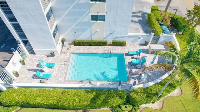 an aerial view of residential houses with outdoor space and trees