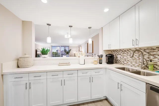 a kitchen with cabinets appliances and a sink
