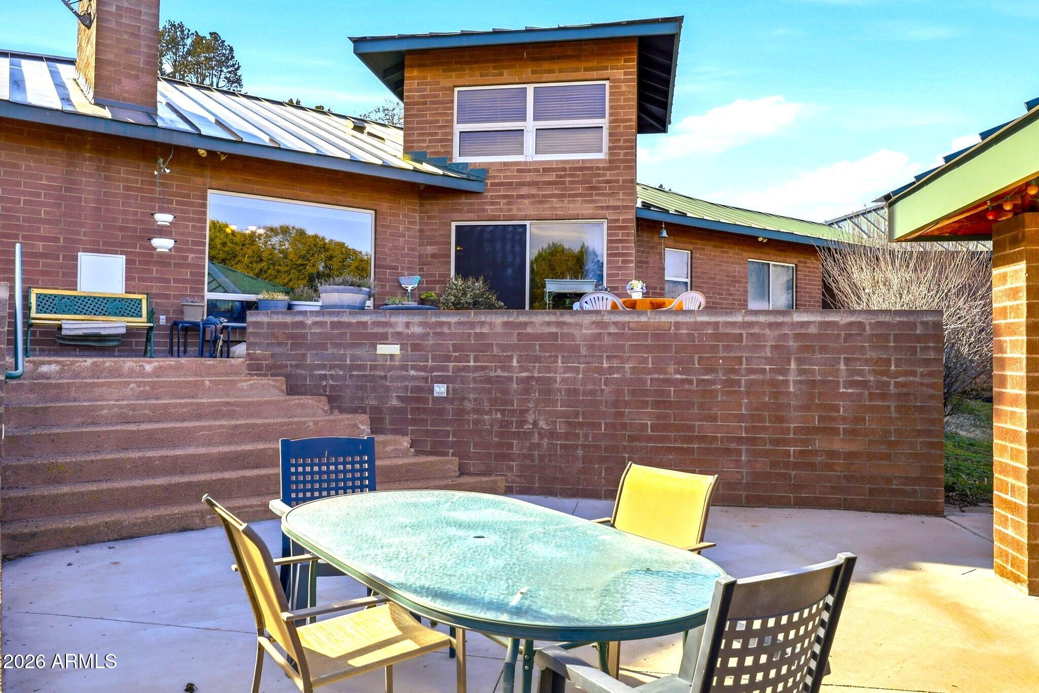 133 South Mule Track Road Young, AZ 85554 - Photo 53 of 65 a brick house with table and chairs