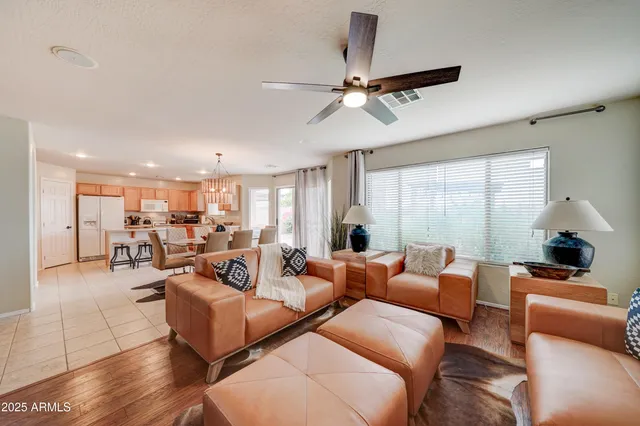 a living room with furniture and a chandelier