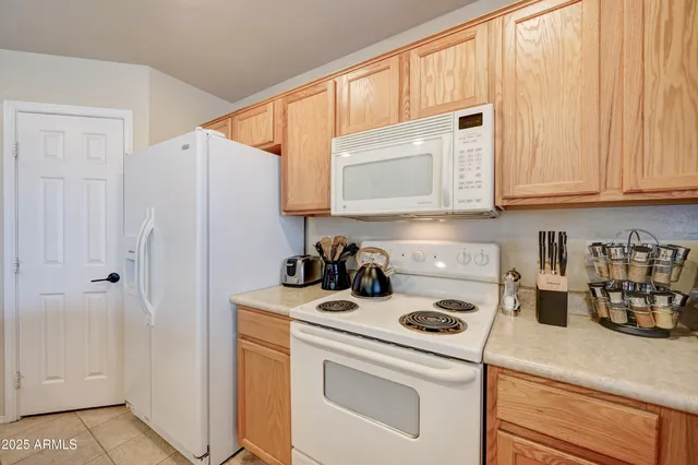 a kitchen with a table chairs sink and cabinets