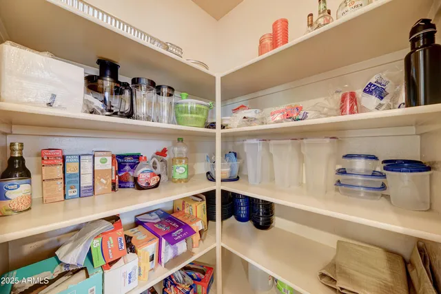 a bedroom with a bed and a lamp on dresser