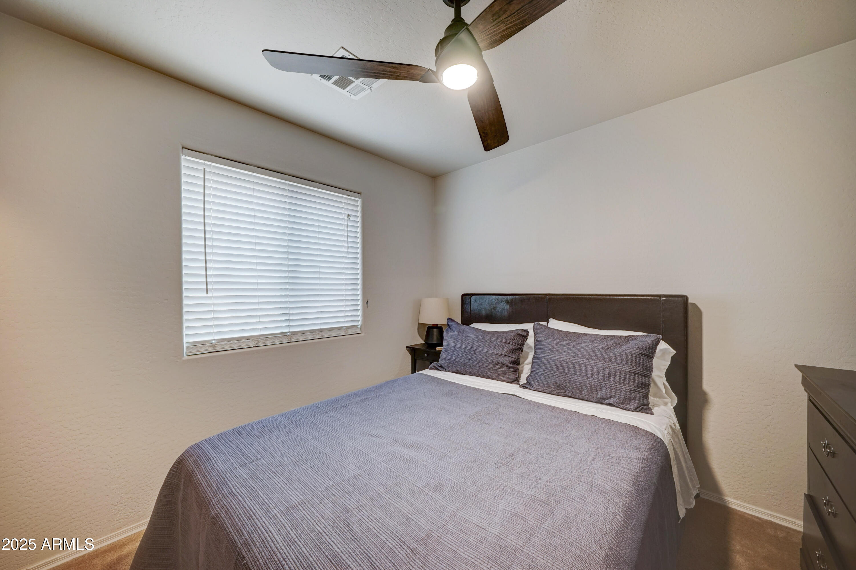 Undisclosed Address San Tan Valley, AZ 85143 - Photo 17 of 57 a bedroom with a large bed and a window