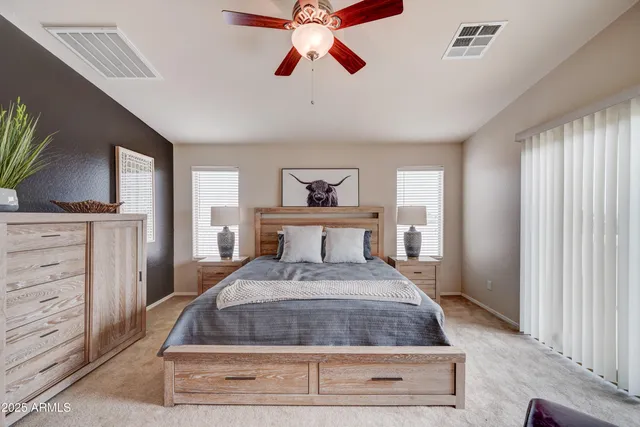 a bedroom with double bed and a large window