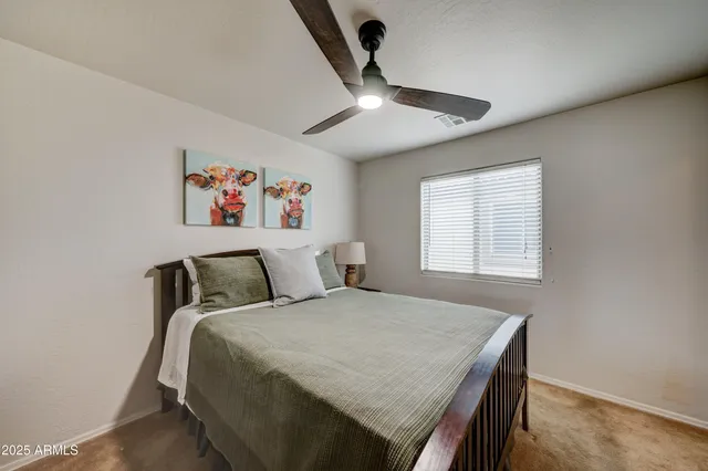a living room with furniture and a ceiling fan