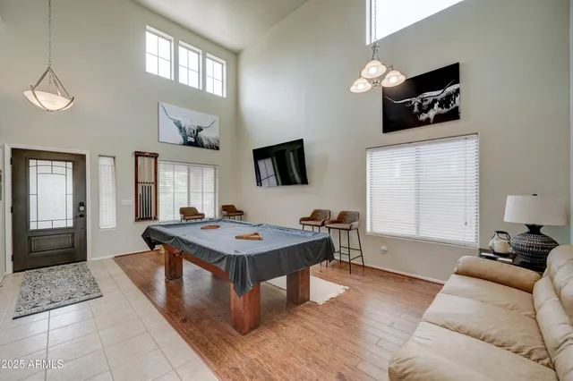 a living room with furniture a flat screen tv and a window