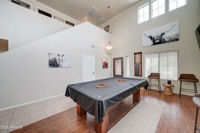 a living room with dining table and wooden floor