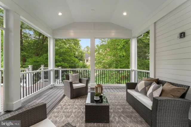 a living room with furniture tv and a large window