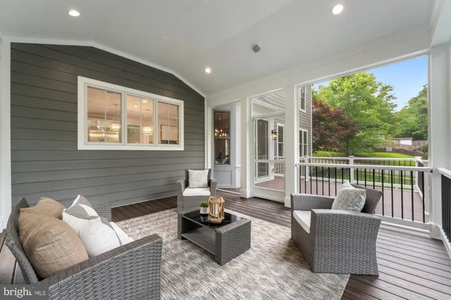 a living room with furniture and floor to ceiling windows
