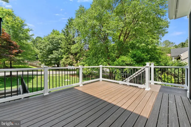 a view of balcony with wooden floor and fence